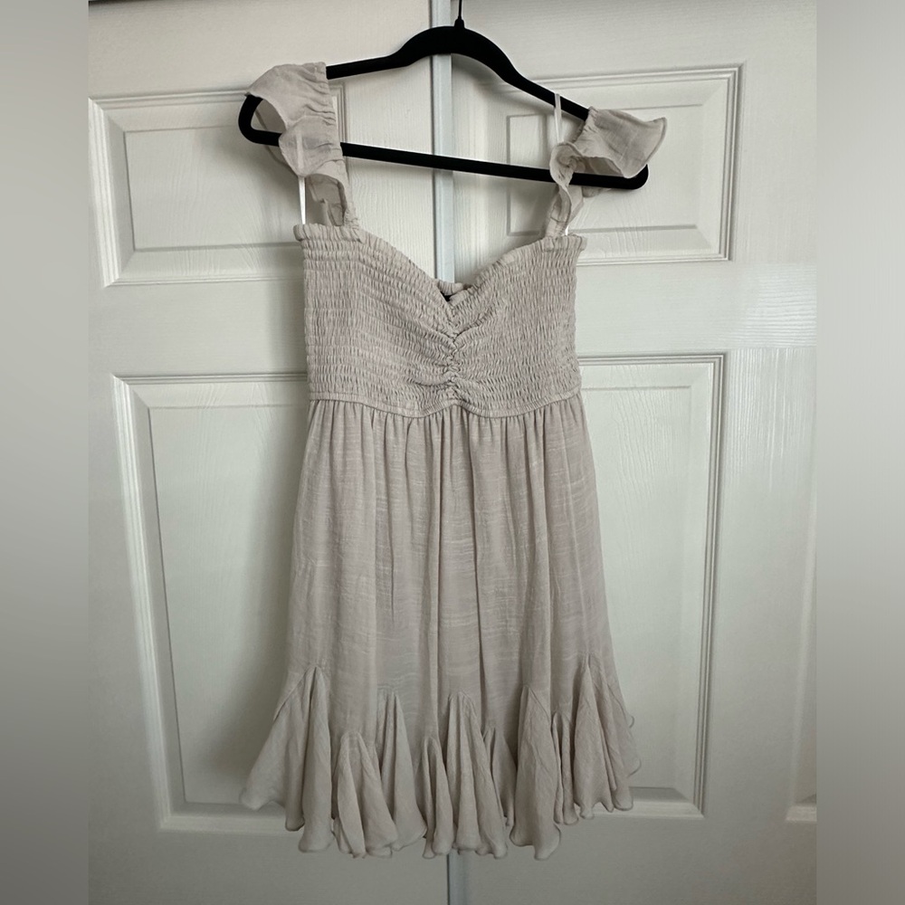 VICI Mahoney Smocked Ruffle Mini Dress in color sand